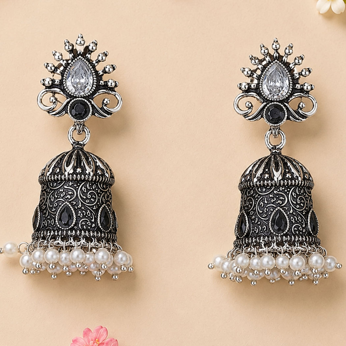 Silver and black ornate oxidized floral jhumka earrings with teardrop crystal and faux pearl dangles for ethnic wear