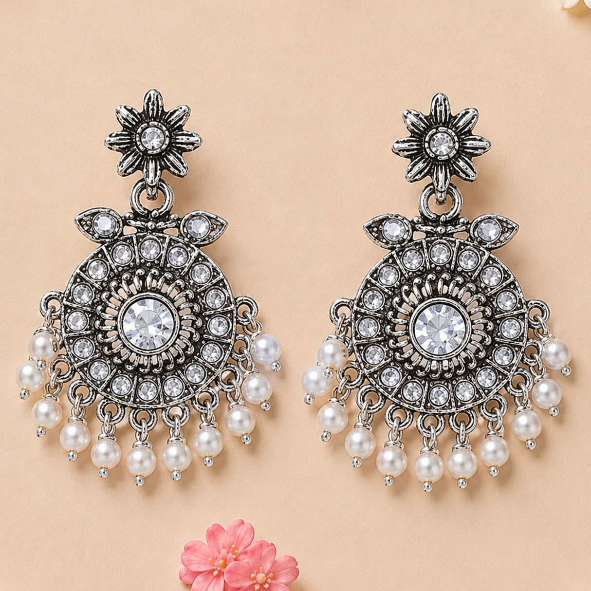 Silver oxidized chandbali earrings with intricate floral design clear crystals and dangling white faux pearls for ethnic wear