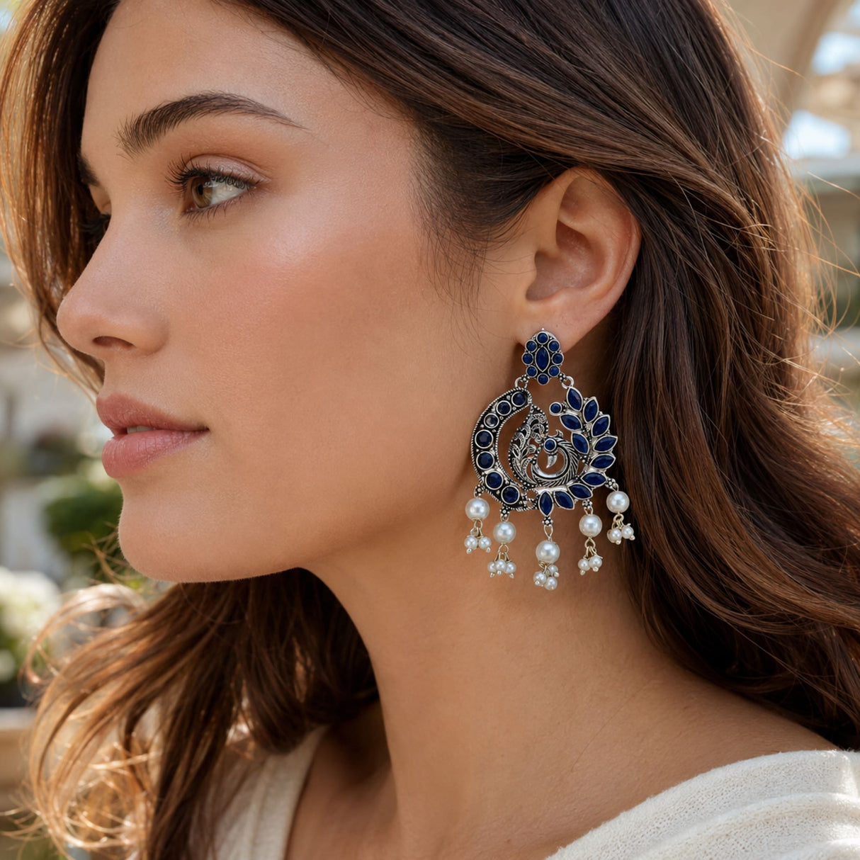 Elegant navy blue and silver boho oxidized chandbali earrings with intricate peacock designs and pearl dangle clusters