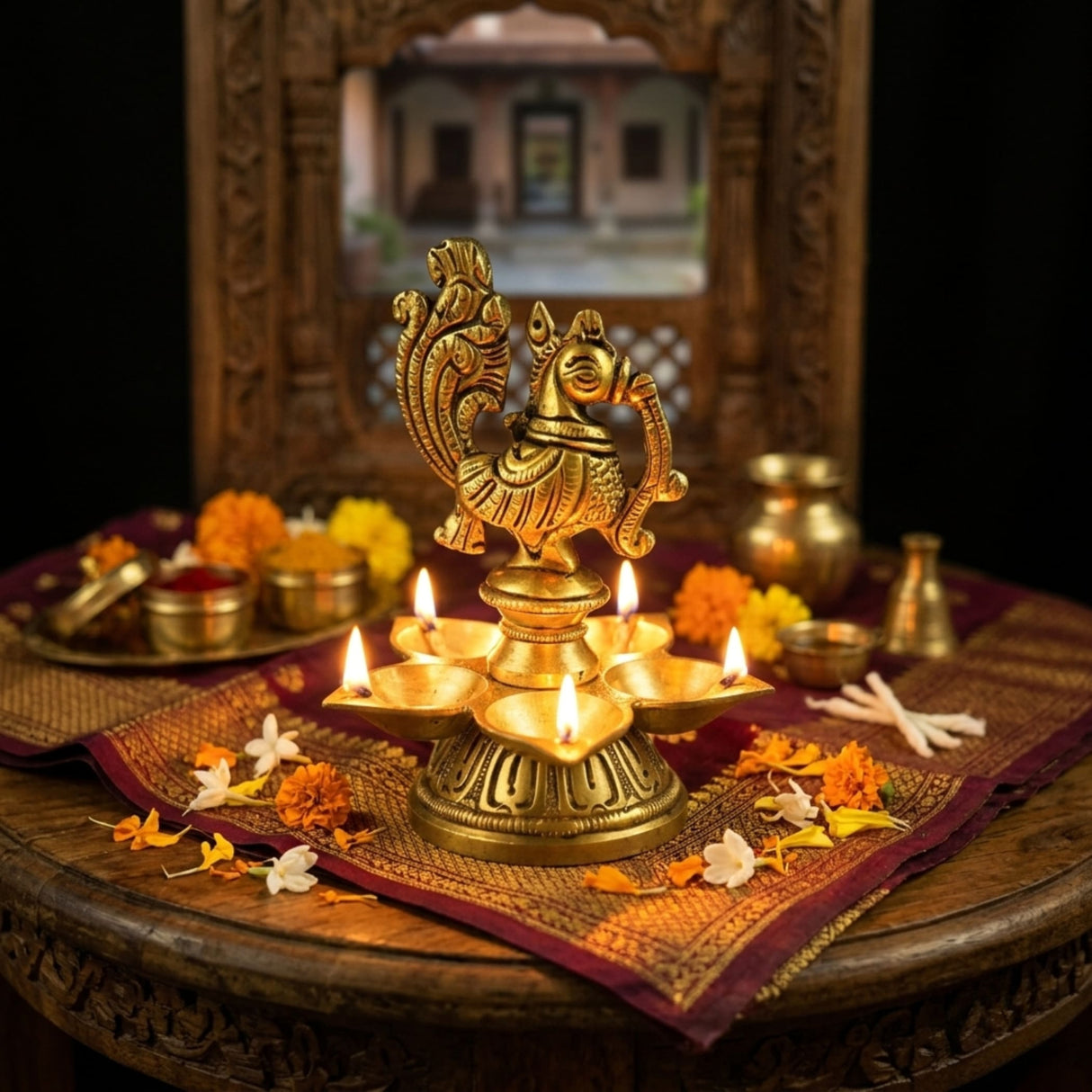 Golden brass peacock diya with five lit oil lamps for Diwali puja