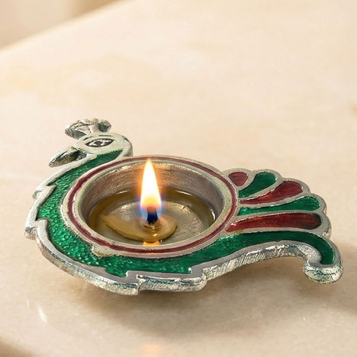 Peacock deepam brass finish diya with silver base and green red enamel accents for diwali puja and home decor