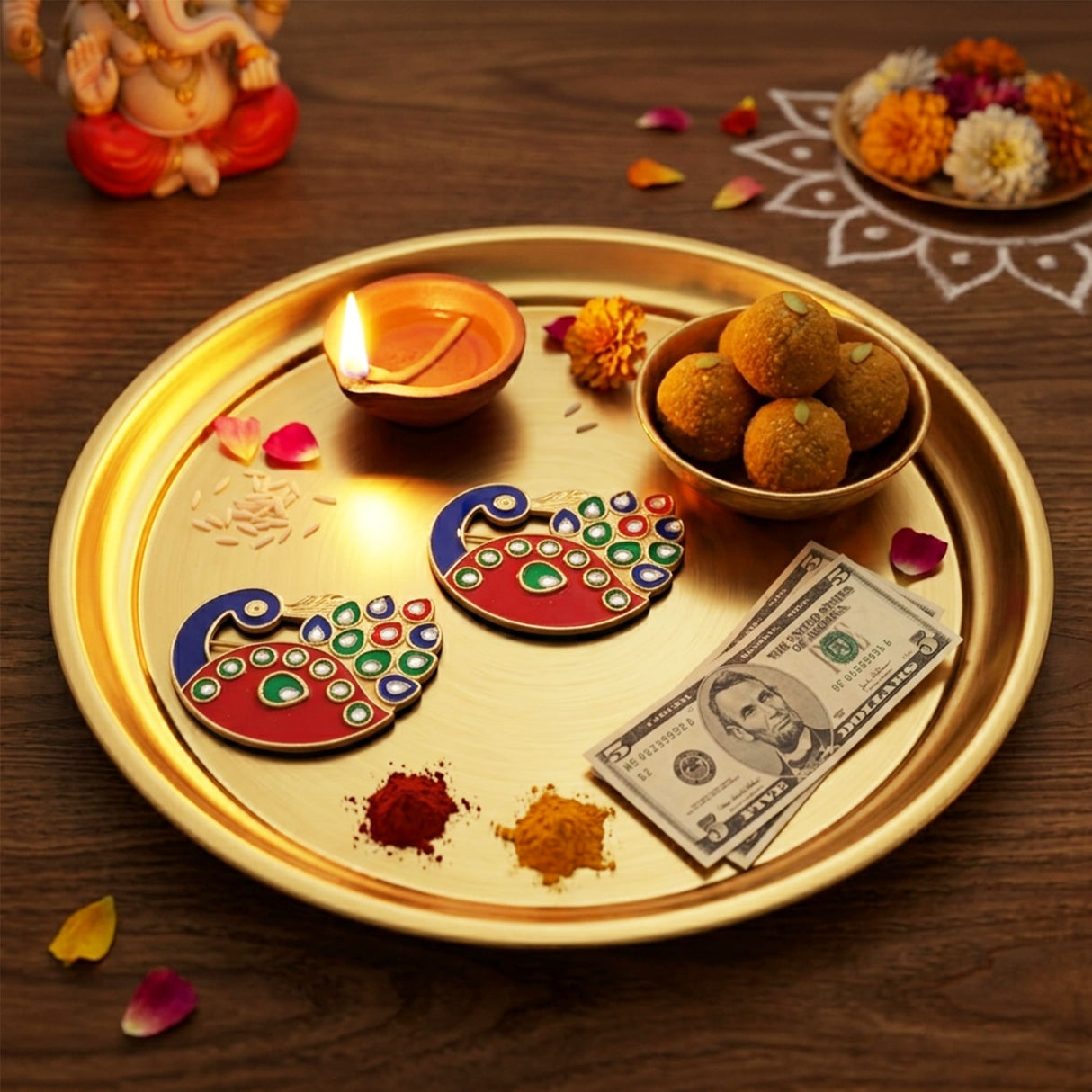 Gold-colored circular decorative bulk peacock haldi kumkum holder with scattered offerings for indian festival pooja