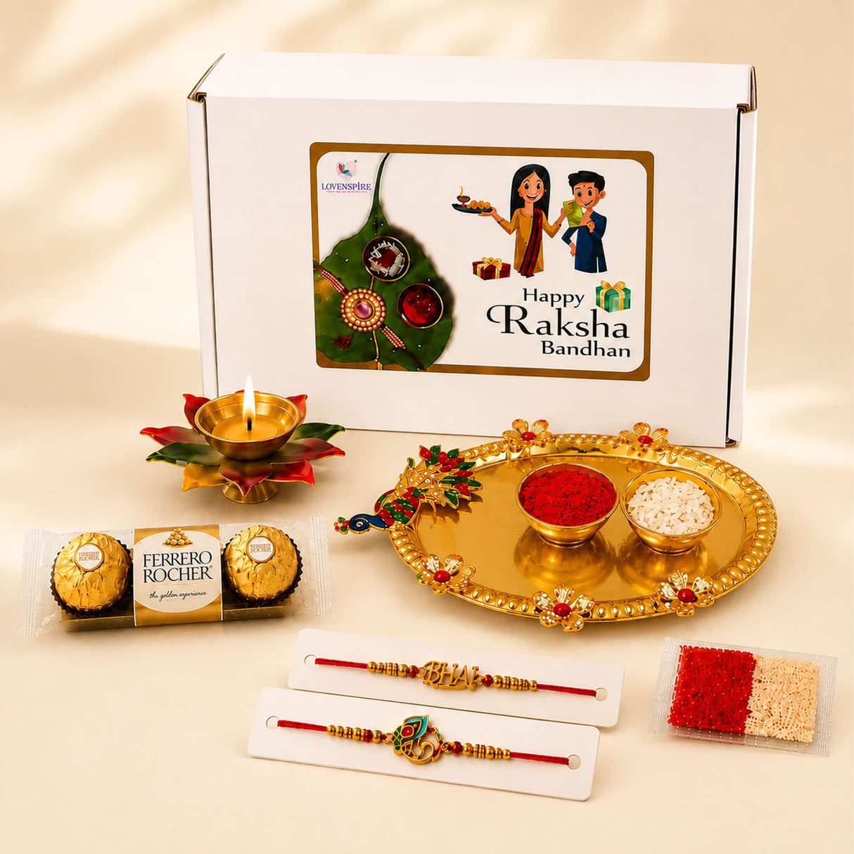 Golden ornate decorative puja plate with floral and peacock motifs holding red roli powder and white rice bowls in peacock rakhi gift hamper set