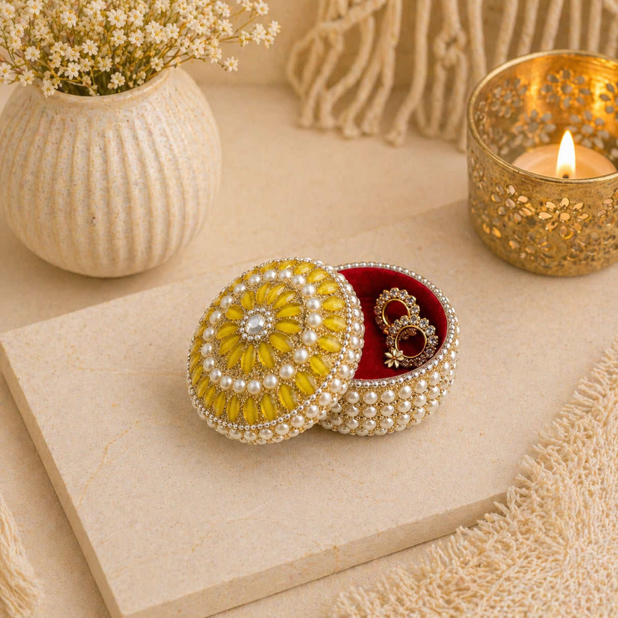 A round yellow pearl-embellished jewelry box with red velvet interior for travel and festival gift use