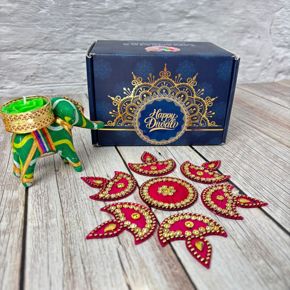Festive Diwali gift set with decorative elephant tealight holder and rangoli decorations