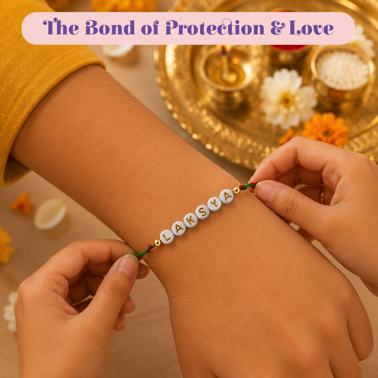 Personalized white beaded rakhi with gold lettering laksya and green cord accents for brother and bhabhi gift