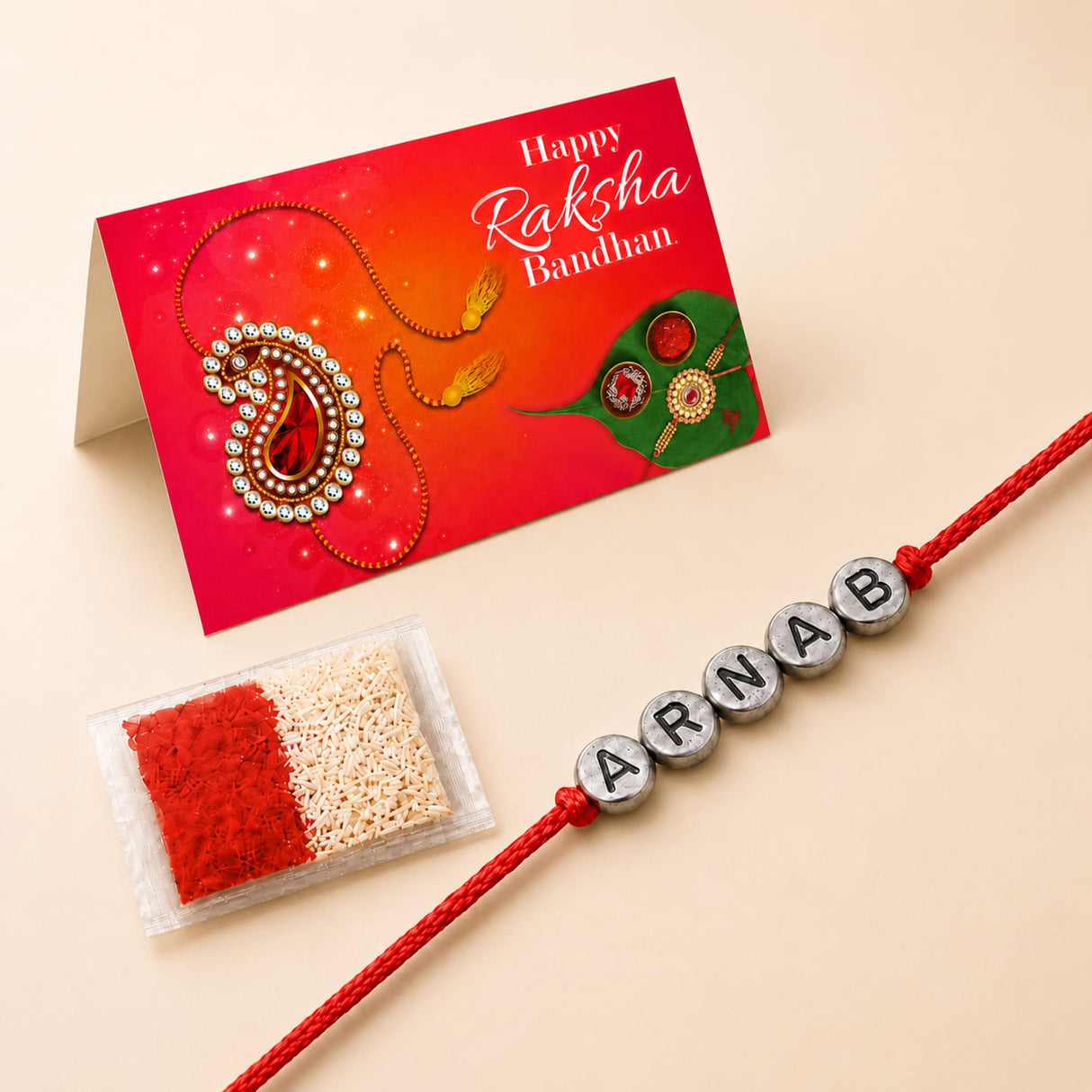 Designer custom named red braided string rakhi with silver beads spelling Arnab for brother and bhabhi protection gift