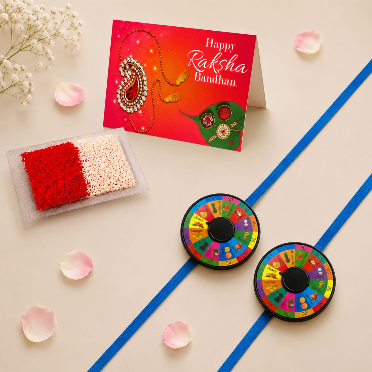 Two colorful circular game wheels with black centers and fruit segments attached to blue ribbons pin wheel rakhi for kids