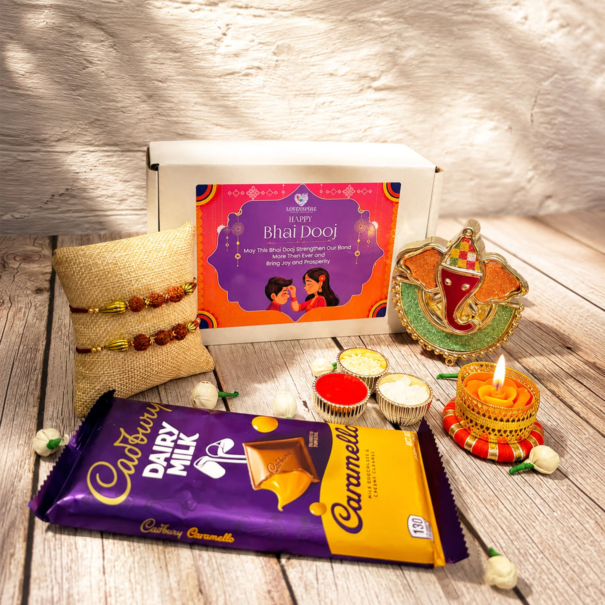 Raksha bandhan gift hamper featuring cadbury dairy milk caramello chocolate bar in purple yellow gold foil packaging