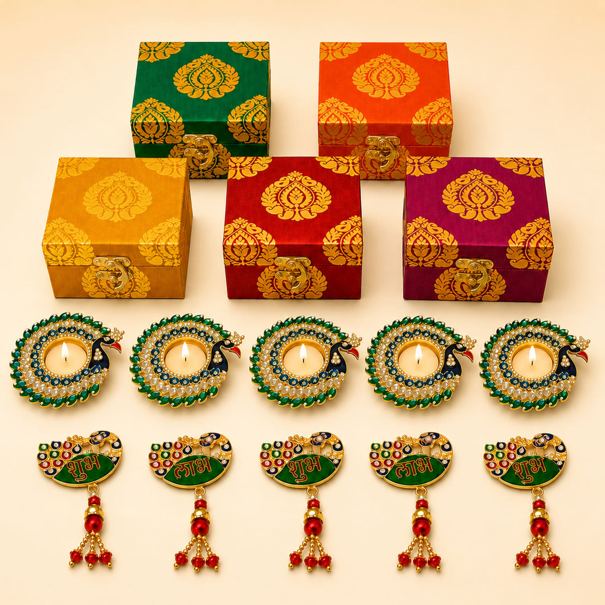 Set of five ornate peacock-themed candle holders with jeweled detailing and tassels in diwali gift hamper box