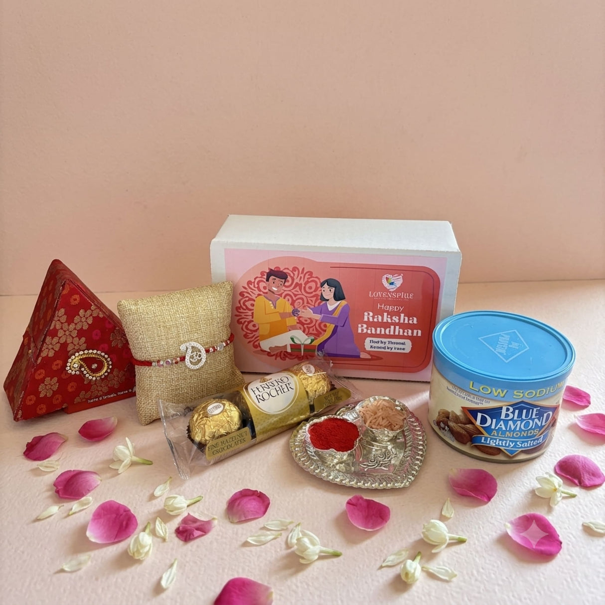 Pure silver om rakhi gift hamper featuring a red and gold patterned triangular brocade gift box with paisley clasp
