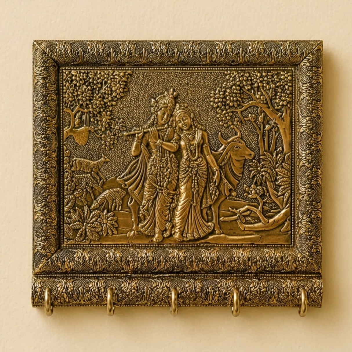 Antique brass wall plaque of radha krishna with cow featuring intricate floral relief and five key hooks for entryway use