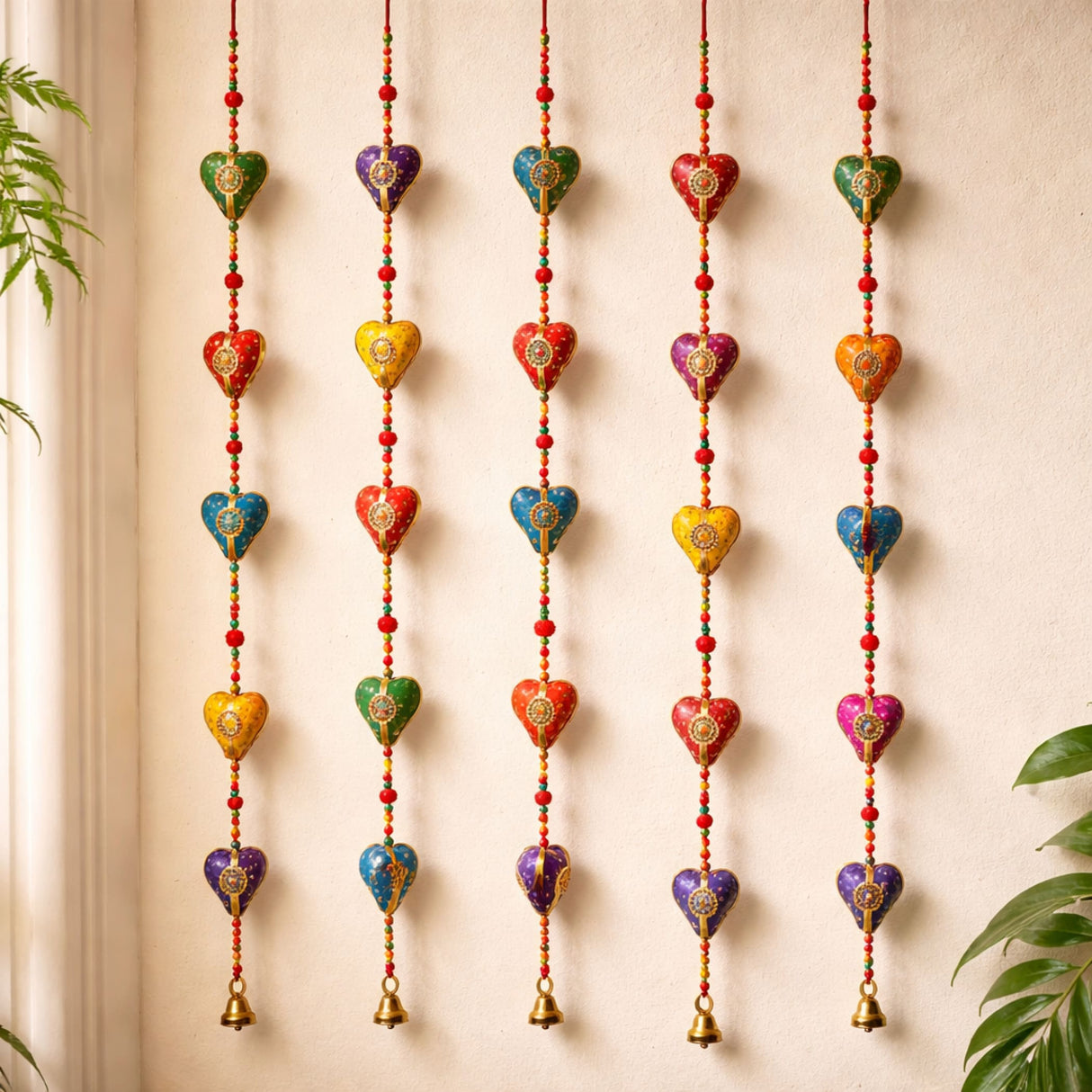 Colorful rajasthani heart-shaped door hanging wind chimes with gold detailing and small bells for diwali and wedding decor