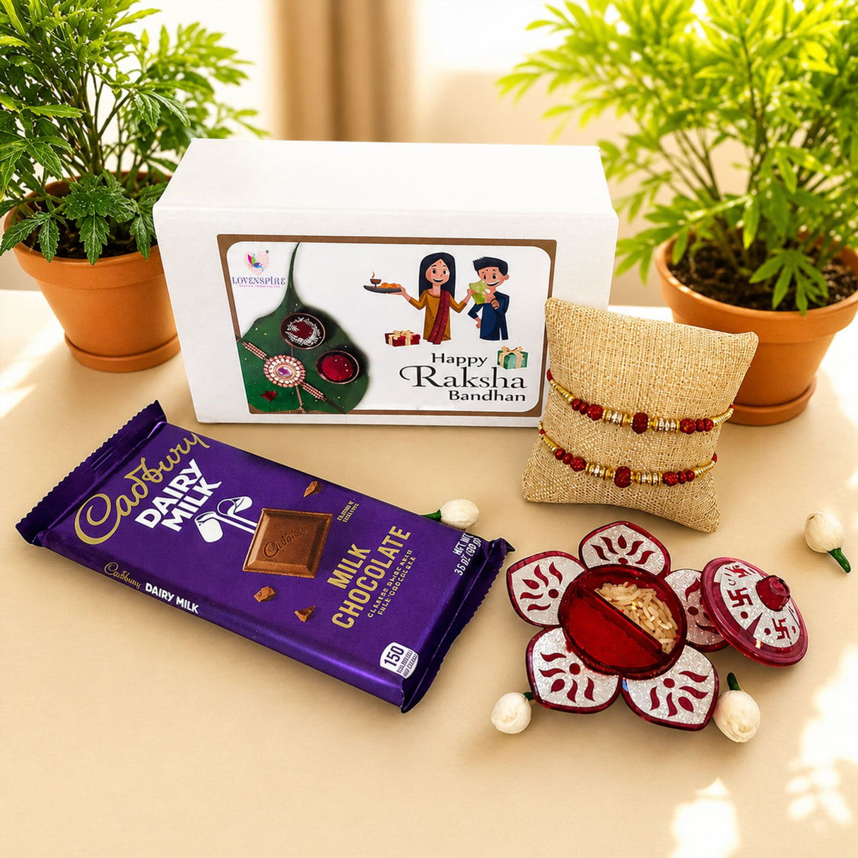 Rakhi gift hamper for brother and bhabhi featuring purple cadbury dairy milk chocolate bar and designer raksha bracelets