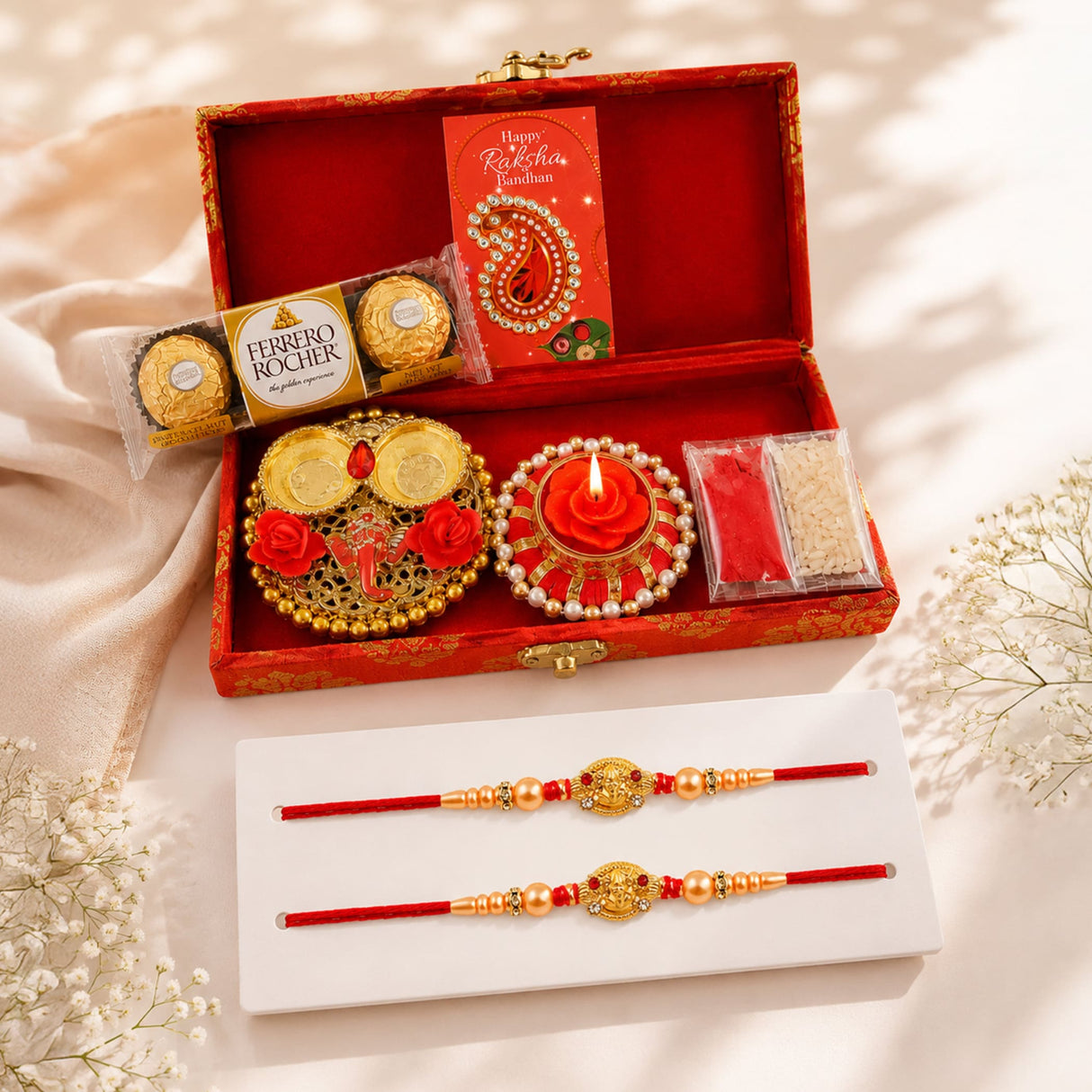 Red and gold brocade gift box rakhi set with intricate beads and ornate charms for brother and bhabhi