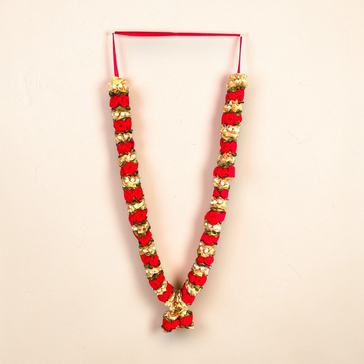 Vibrant red gold Varmala wedding garland with velvet petals for bride groom