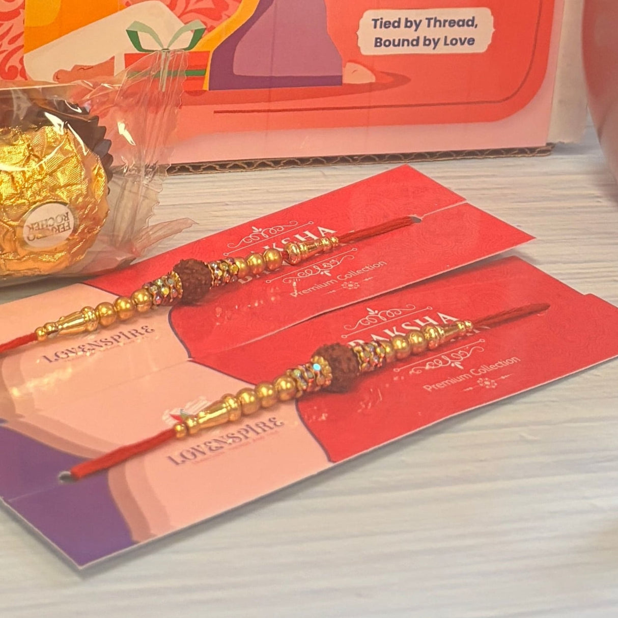 Traditional Rudraksha Rakhi Gift Hamper for Brother & Bhabhi – Adjustable Rakhi Bracelet with Tumbler, Chocolates, Roli Chawal & Card for Raksha Bandhan
