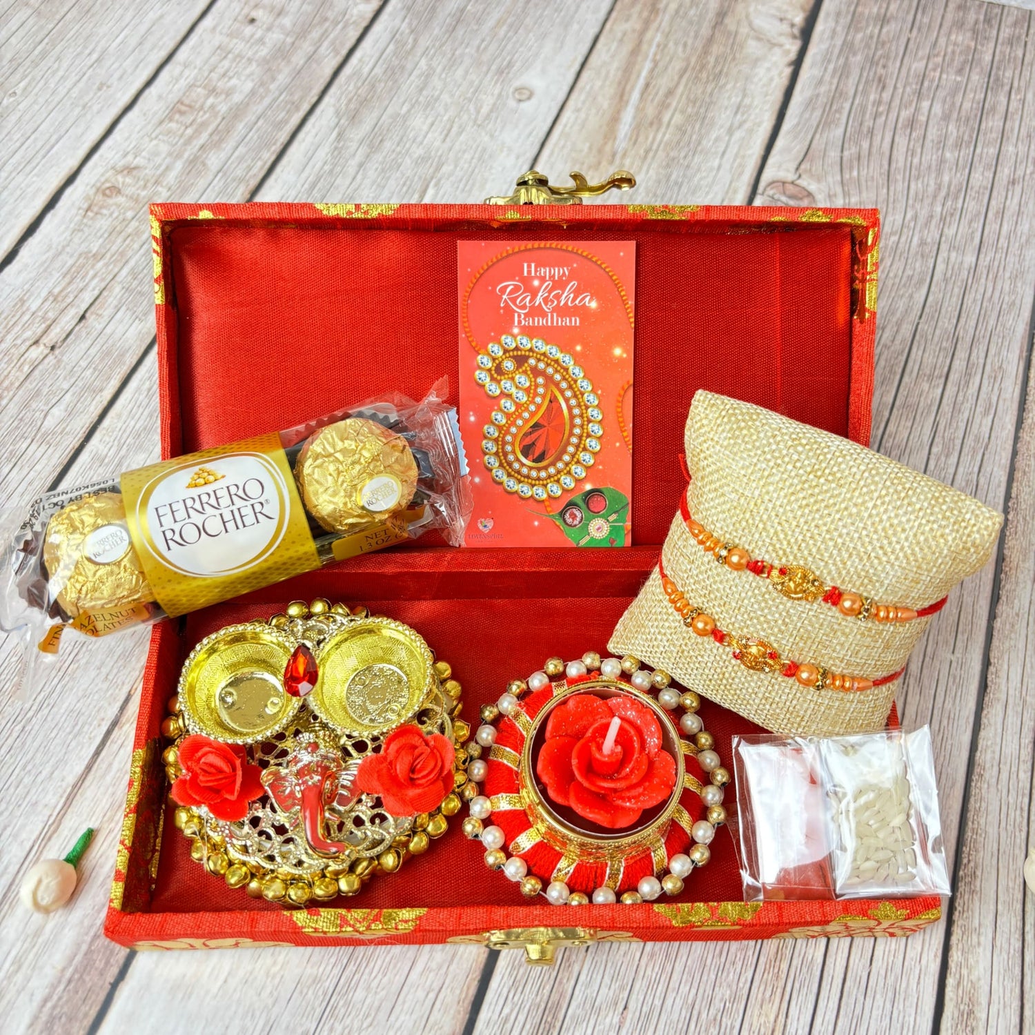 Raksha Bandhan gift box with Rudraksha Rakhi, chocolates, candle holder, and rakshabandhan card
