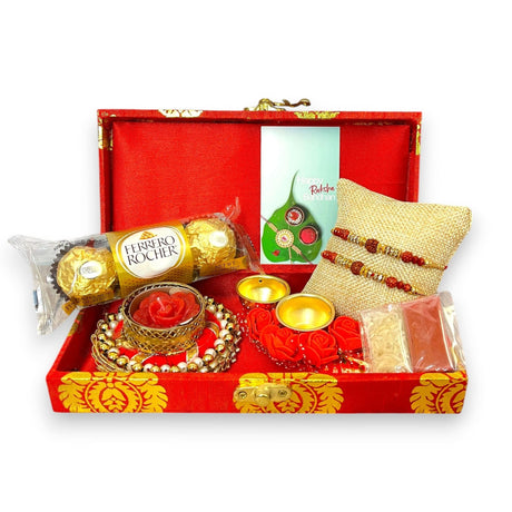 Rakhi gift box with Rudraksha Rakhi, chocolates, candles, Haldi Kumkum, and Rakshabandhan card