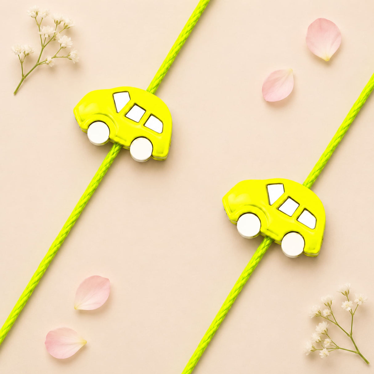 Cute cartoon car rakhi bracelet featuring bright yellow plastic car charms with white wheels on lime green cords