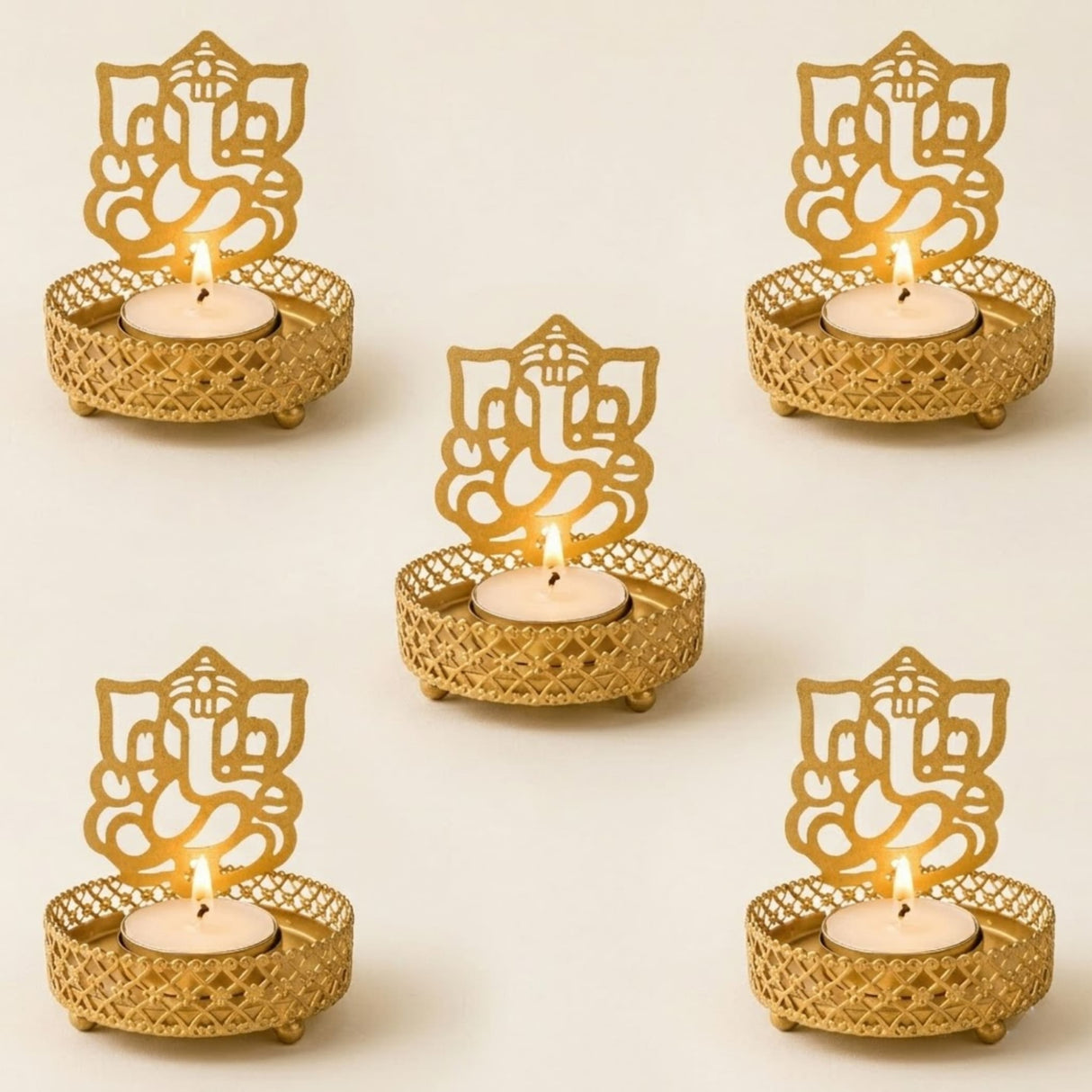 Gold-colored intricately designed ganesha themed tea light candle holders with mesh pattern and small feet for diwali decor