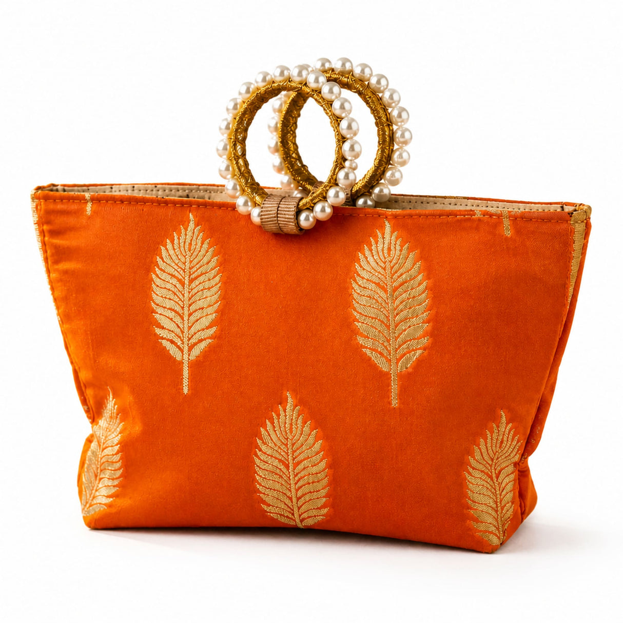 Eid gift orangish-orange silk handbag with gold leaf embroidery and pearl adorned golden handles for wedding and Diwali favors