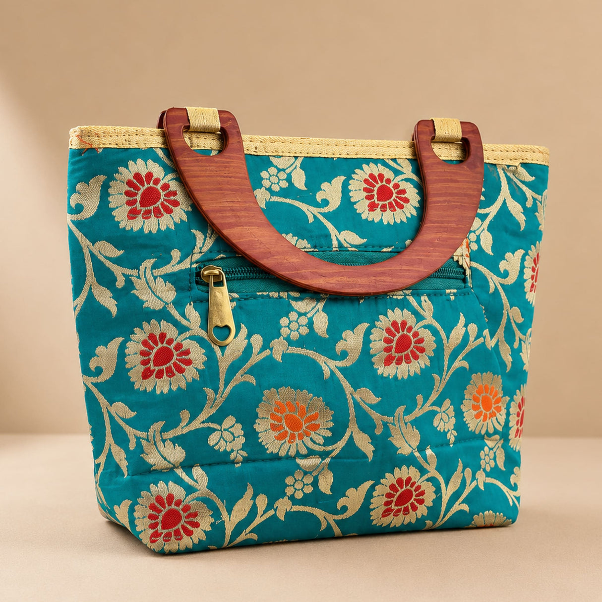 Traditional Indian embroidered teal silk handbag with floral pattern wooden handles and gold-tone zipper for festivals