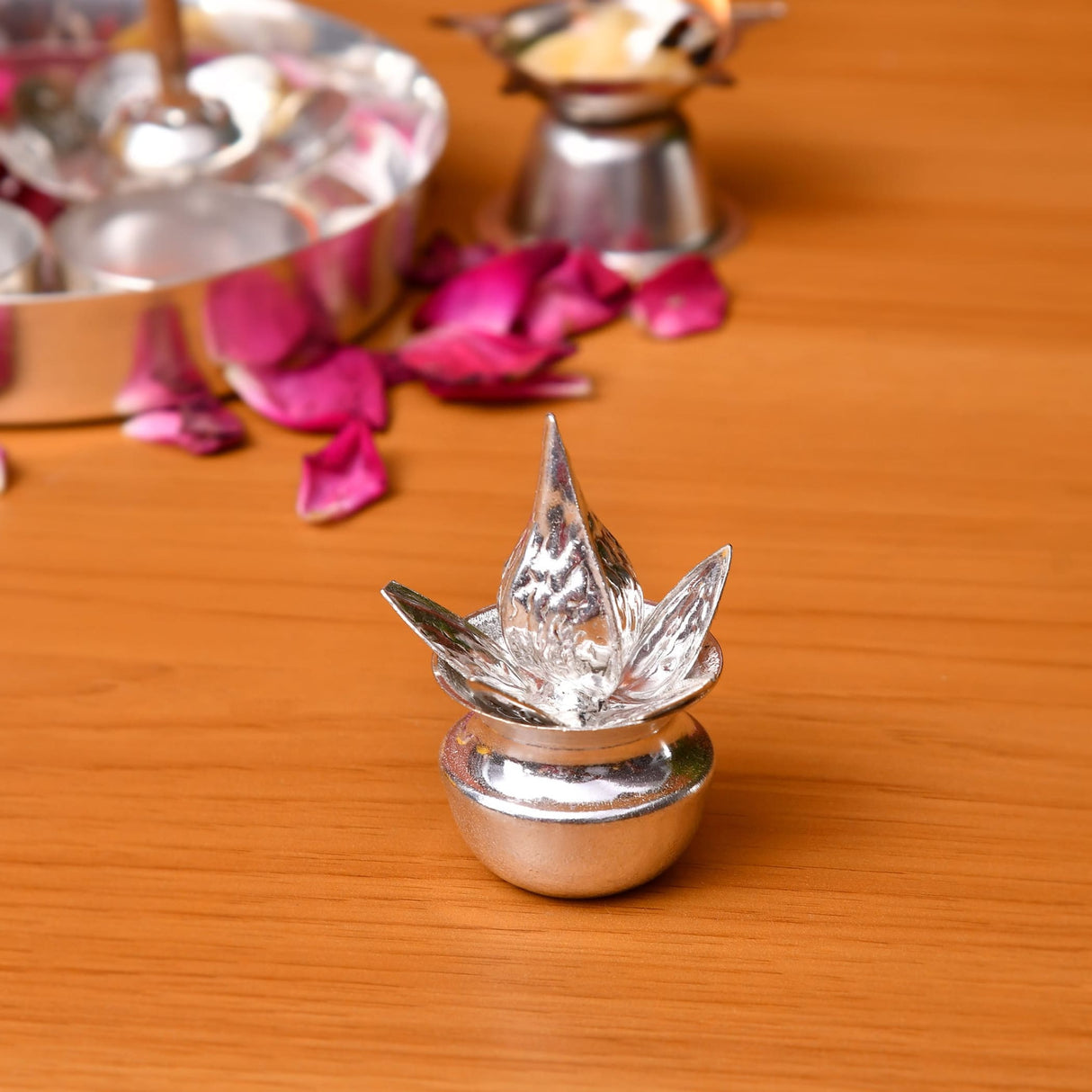Silver plated mini mangal kalash oil lamp in lotus shape with intricate petals and rounded base for pooja and home decor