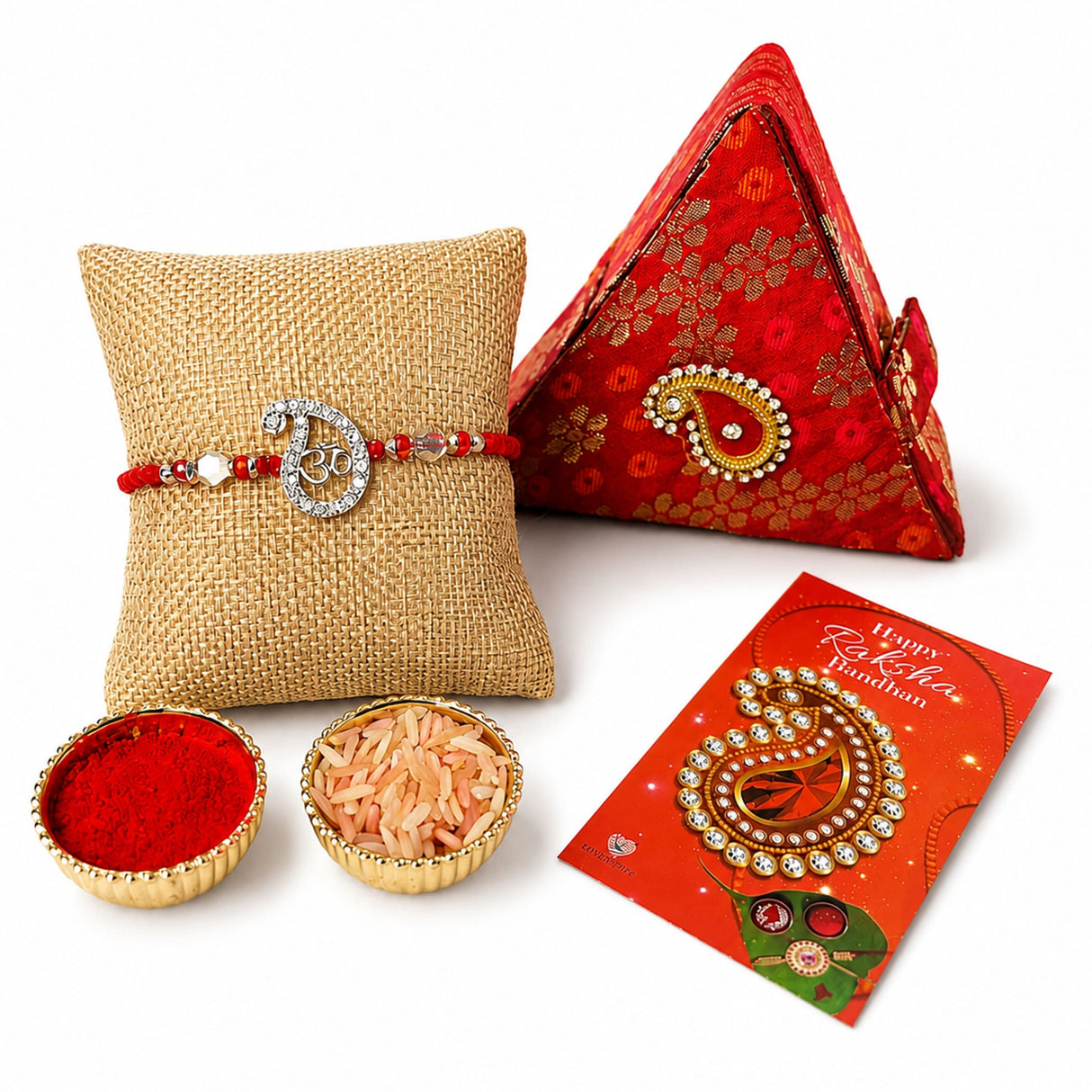 Designer pure silver Om rakhi with red and gold paisley design, red beads, and clear crystal accents for Raksha Bandhan