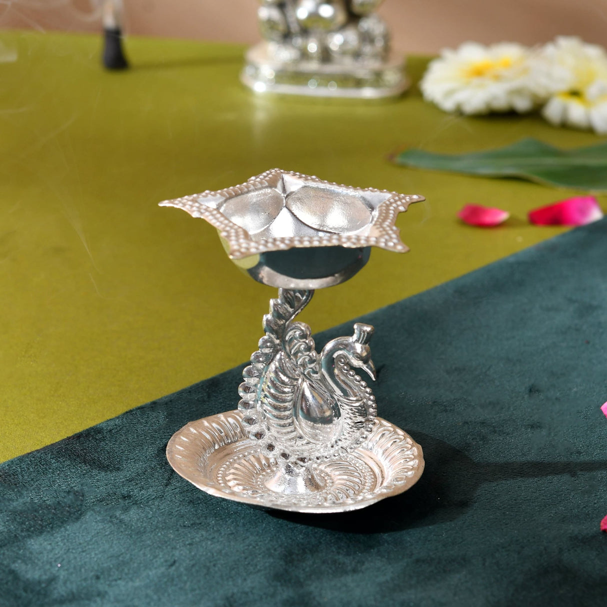 Silver plated peacock diya oil lamp with star shaped top and ornate base for home pooja mandir and Diwali decor