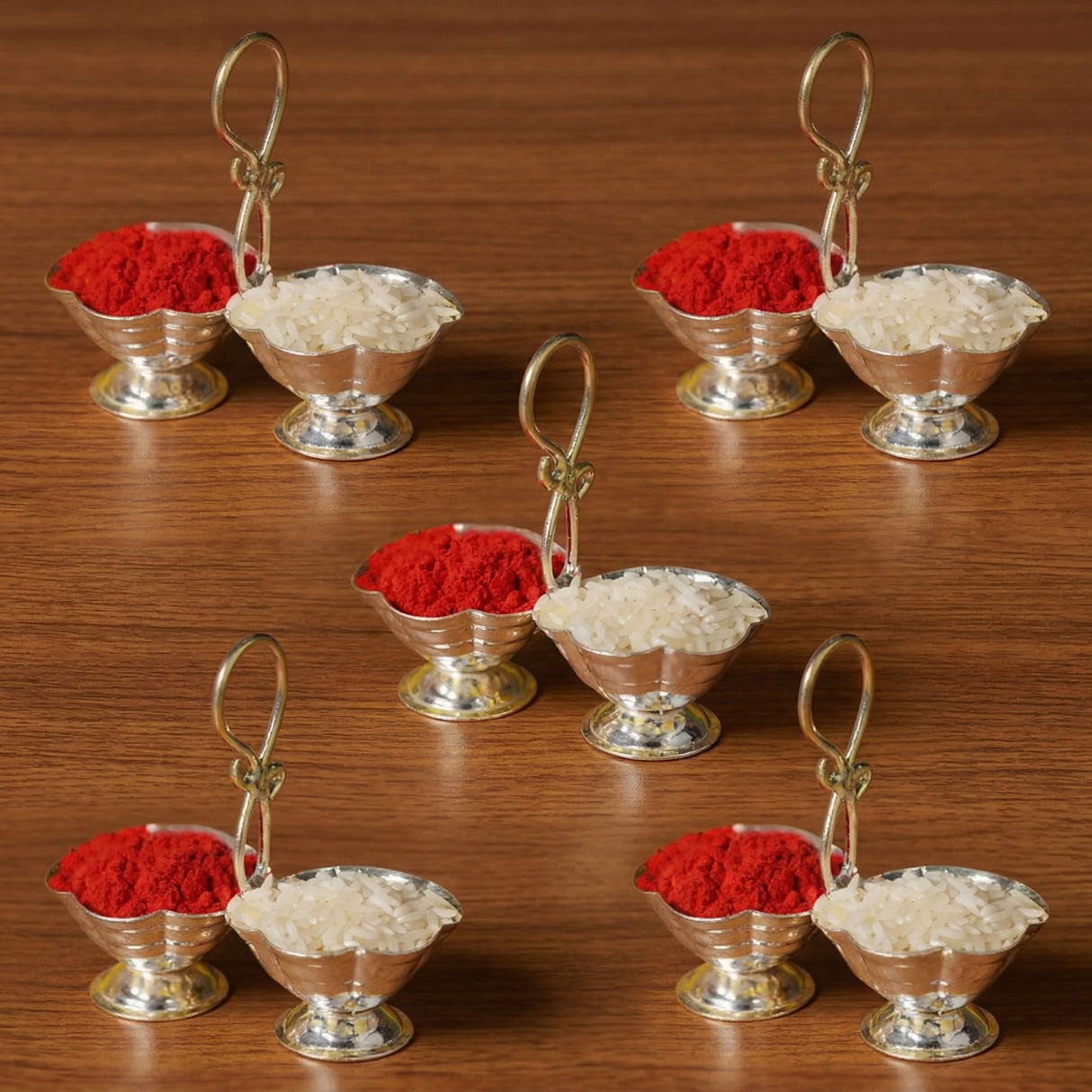 Silver colored ornate miniature silver plated haldi kumkum holder with handle and pedestal base for puja use