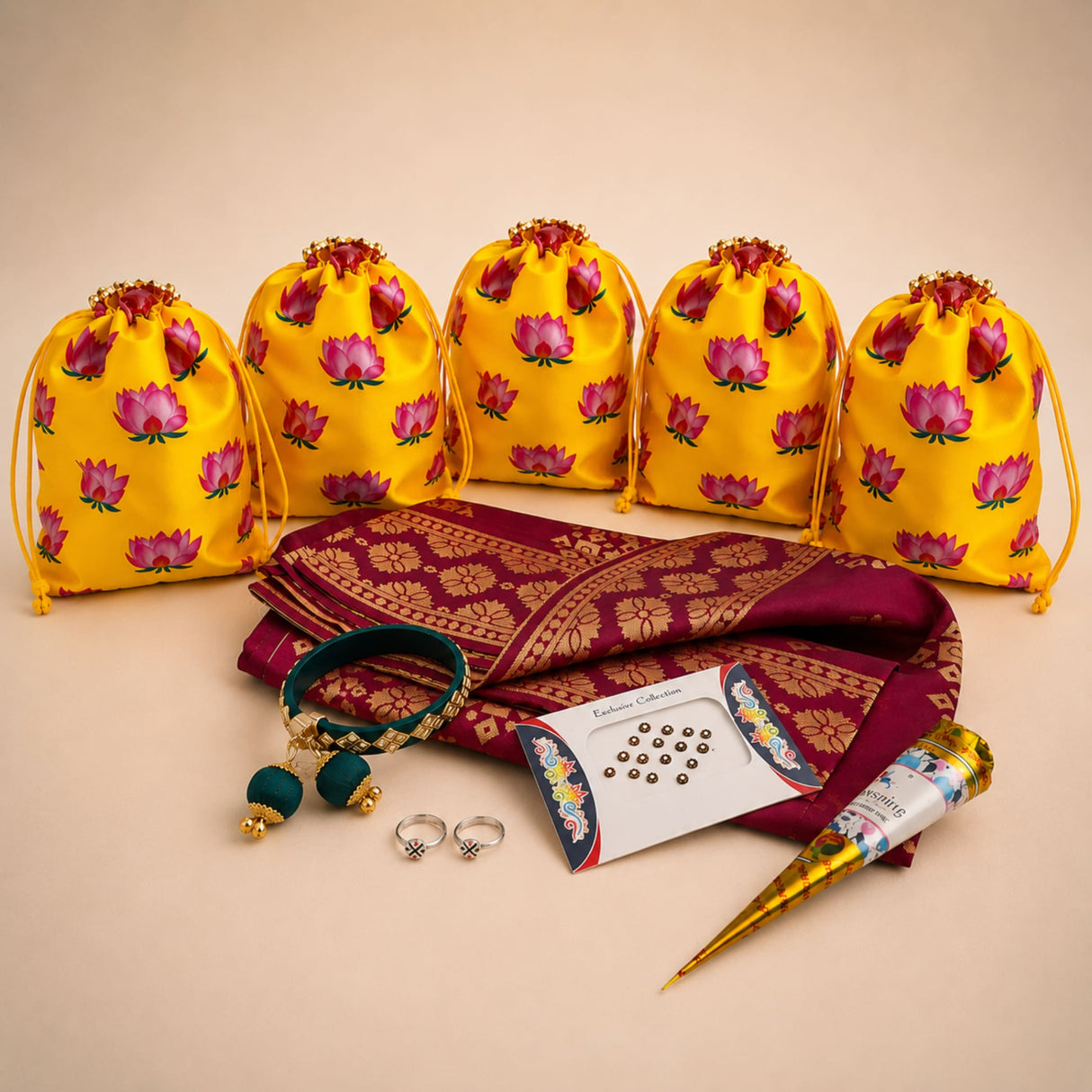 Yellow drawstring potli bags with pink lotus prints for karva chauth gift hamper and festive return gifts