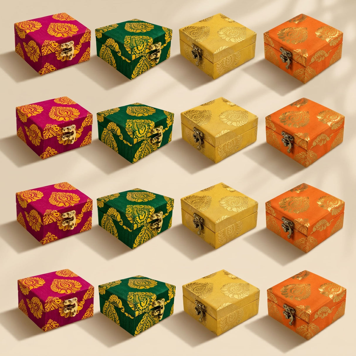 Small handmade square jewelry boxes in magenta green yellow and orange with gold brocade and metallic clasps for weddings