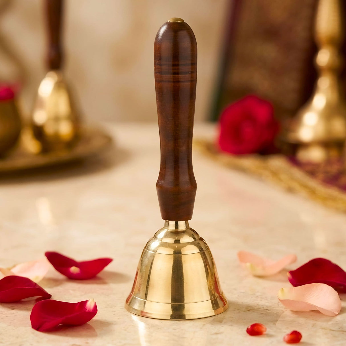 Polished solid brass hand call bell with dark brown wooden handle and horizontal grooves for grip used in prayer and ceremonies