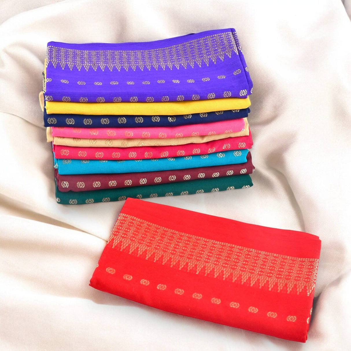 Colorful folded scarves with gold patterns displayed with Unstitched Blouse Pieces for Women