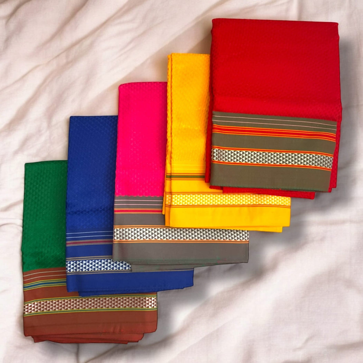 Colorful folded sarees displayed with Unstitched Blouse Pieces for traditional women’s attire