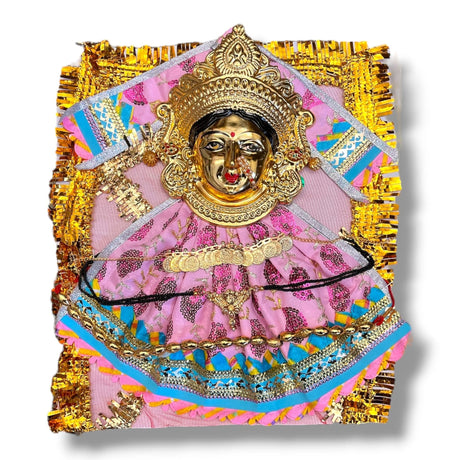 Golden-faced Devi Mata goddess figure in pink dress with jewelry for Navaratri puja
