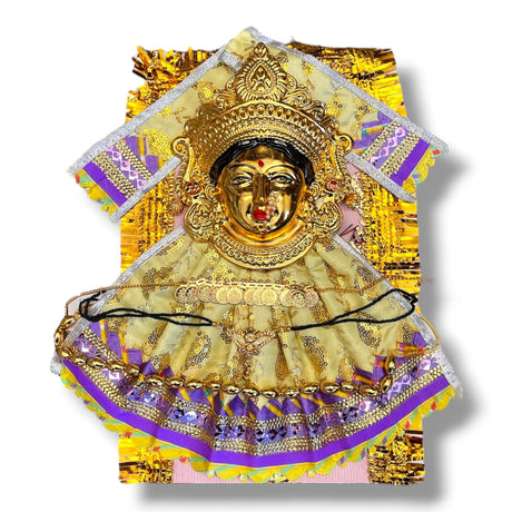 Golden Hindu deity statue adorned with ornate clothing and jewelry for religious rituals