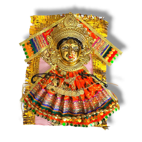 Golden Hindu deity figurine with colorful fabric and jewelry for Navaratri Pooja worship