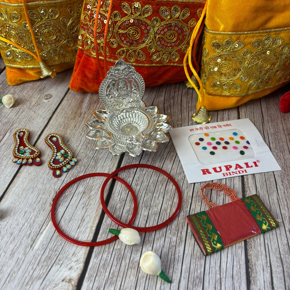 Indian religious gift set with Potli Bags, Diya, Bindi, Bangles, and ceremonial items
