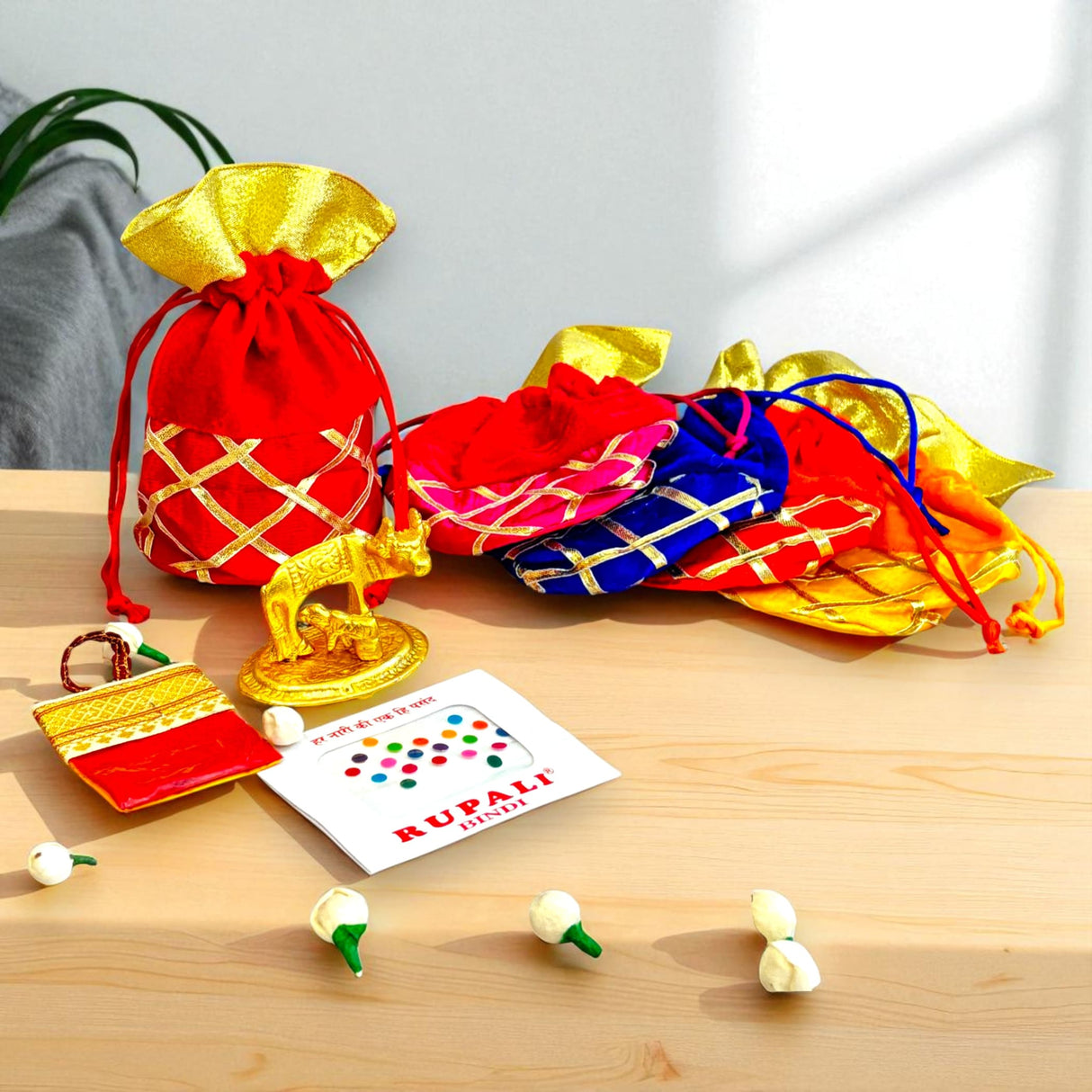 Colorful gift bags with gold accents from Varalakshmi Vratham Navaratri Pooja collection