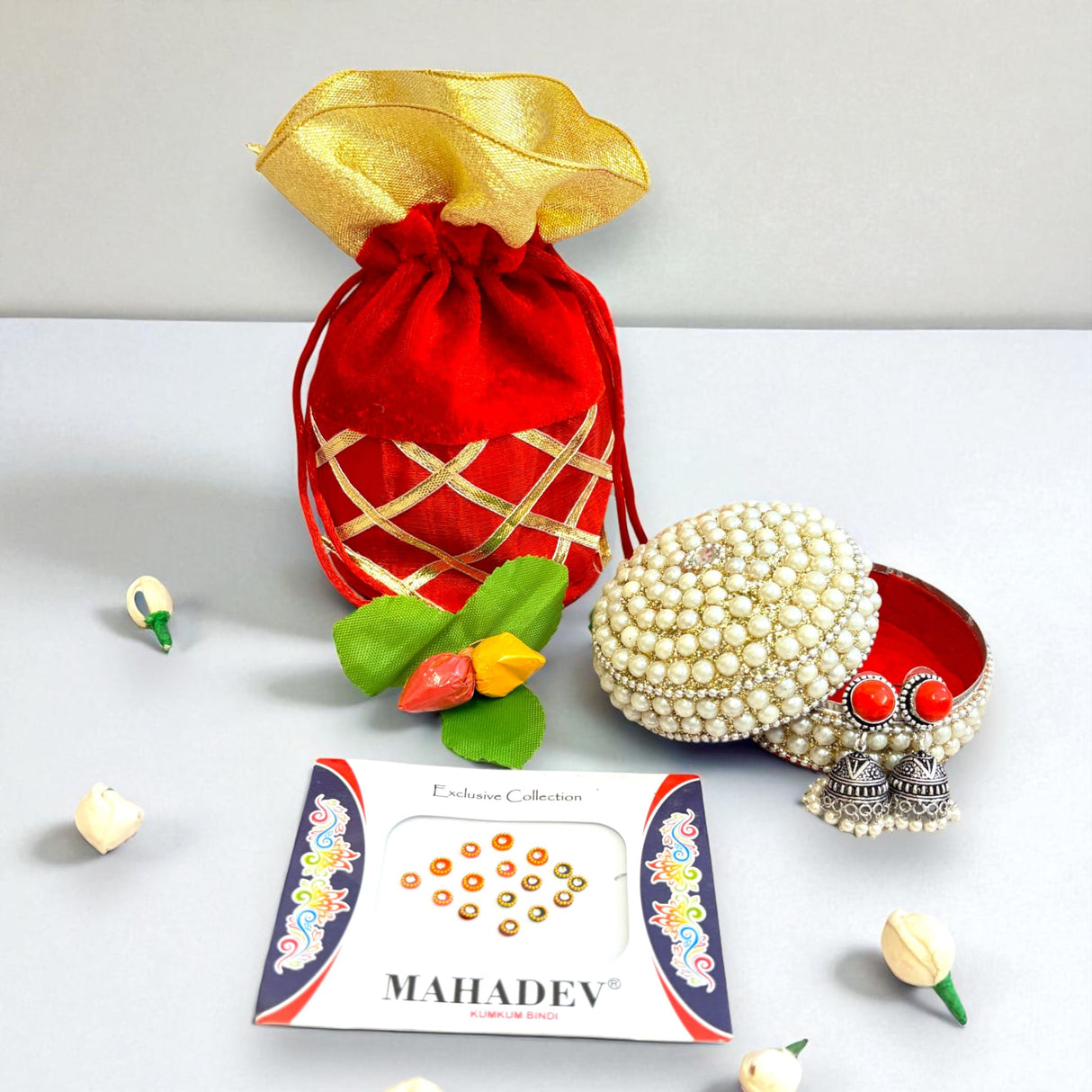 Red and gold gift bag with jewelry and bindis for Varalakshmi Vratham celebrations