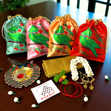 Colorful parrot-themed gift bags and Indian wedding items in a Varalakshmi Vratham hamper