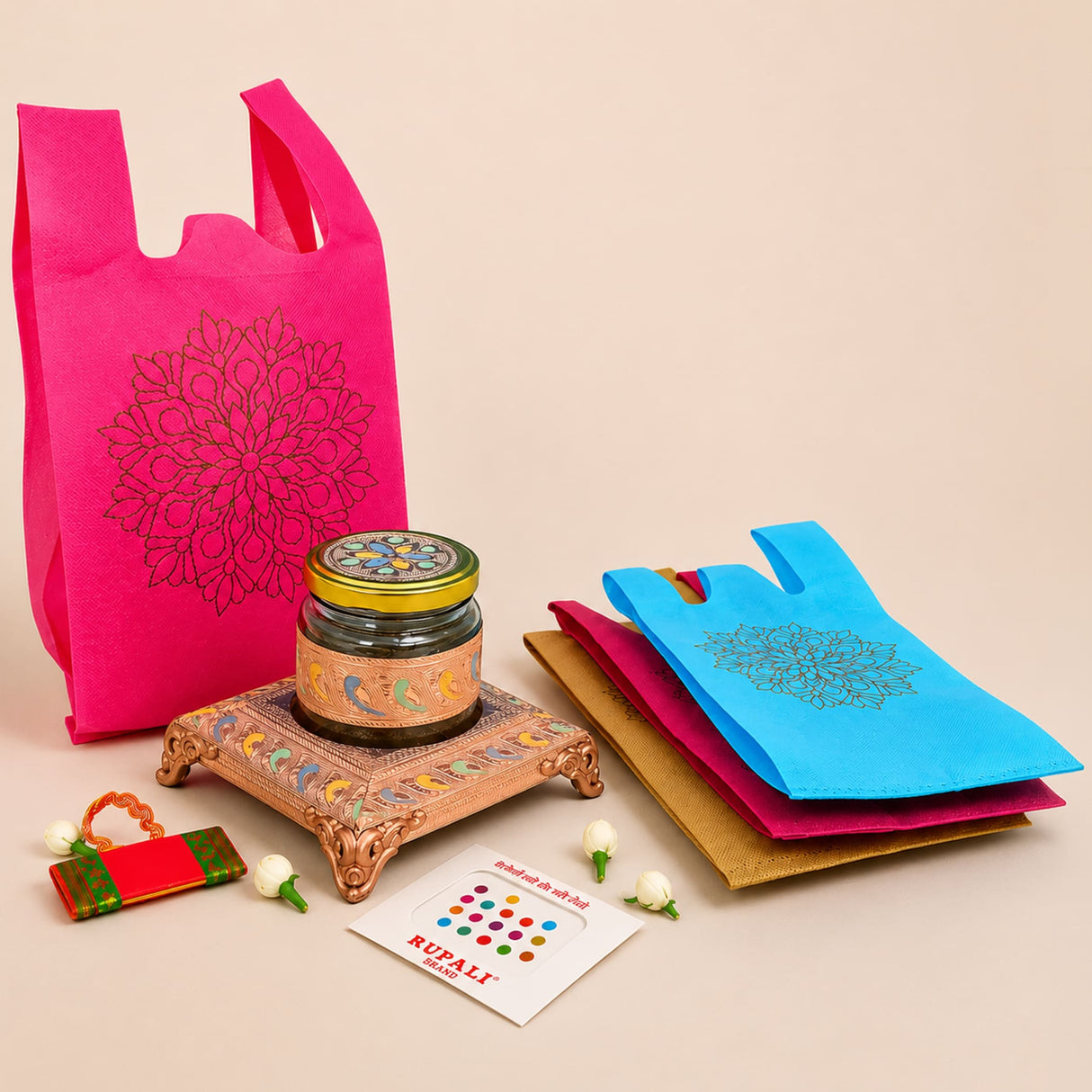 Vibrant pink reusable non-woven tote bag with intricate black floral embroidery for Varalakshmi Vratham gift hamper