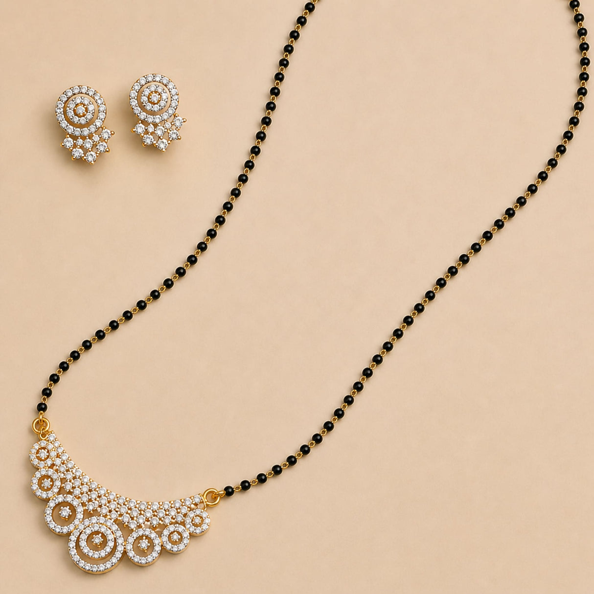 White stone mangalsutra necklace set with gold-toned crescent pendant, sparkling stones, black beads, and matching earrings