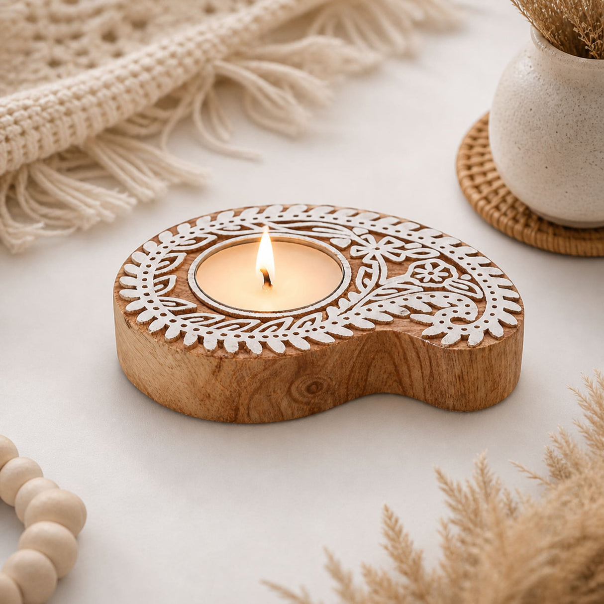 Wooden block print tealight holder with white laser-cut floral patterns and natural wood finish for Diwali decoration