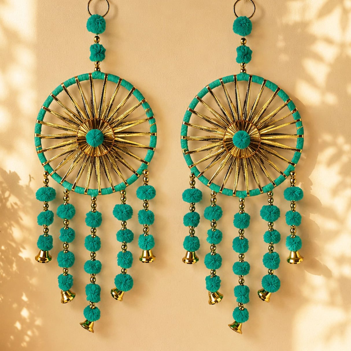 Turquoise and gold dreamcatcher style earrings with pom pom tassels and small bells perfect for traditional decor