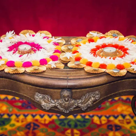 A beautifully decorated home for Diwali with colorful diya lamps, marigold garlands, twinkling lights, paper lanterns, and intricate rangoli patterns.