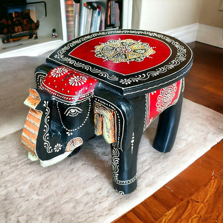 Hand-painted handcrafted wooden elephant stool with black body red accents and intricate white floral patterns for living room decor