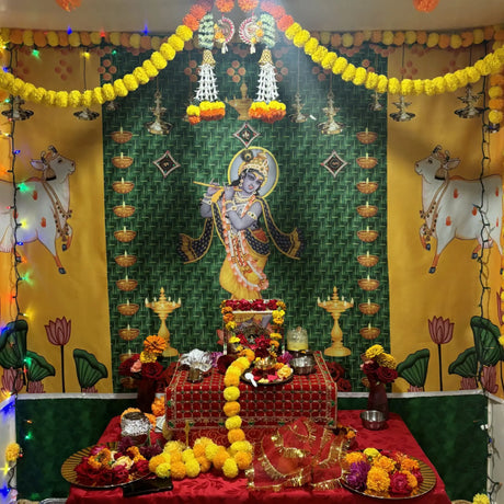 Golden Krishna statue in pooja backdrop decoration with red and gold accents.